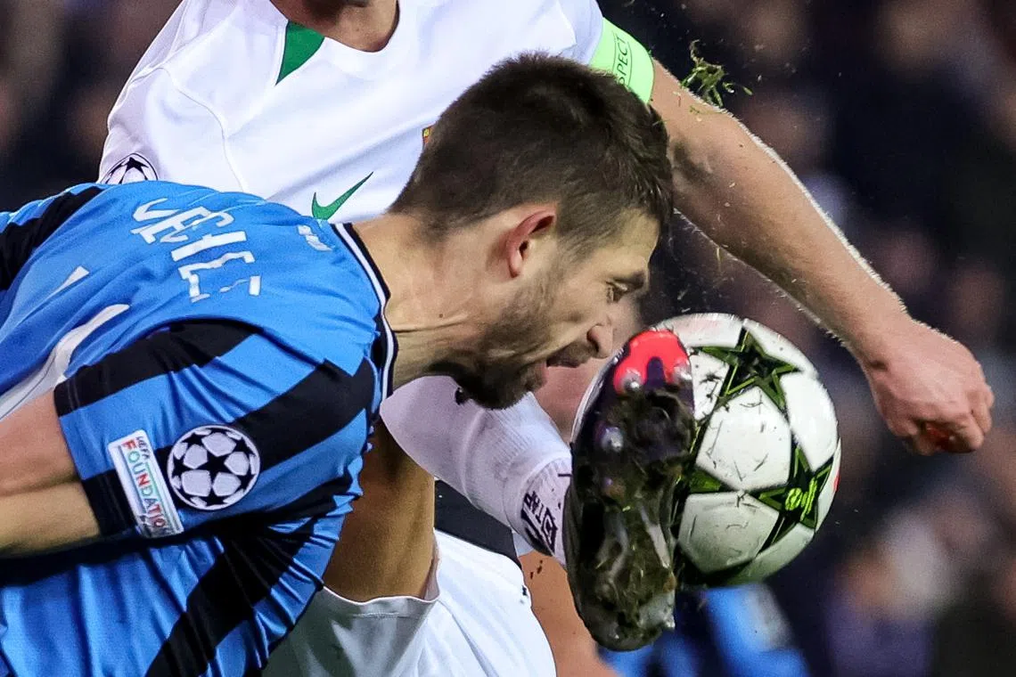 Brandon Mechele of Brugge (front) in action against Morten Hjulmand of Sporting, during the UEFA Champions League soccer match between Club Brugge and Sporting CP in Bruges, Belgium, on Dec 10, 2024.  