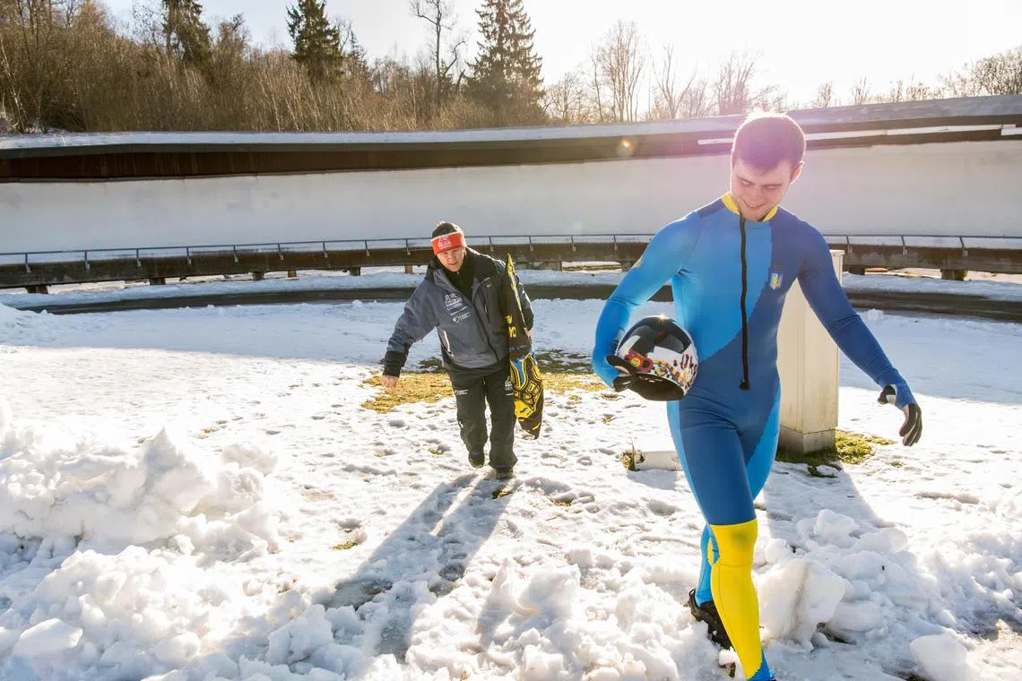 Vladyslav Heraskevych, a Ukrainian skeleton racer, with his father and head coach Mykhailo Geraskevych in Kyiv on Feb 14, 2023.