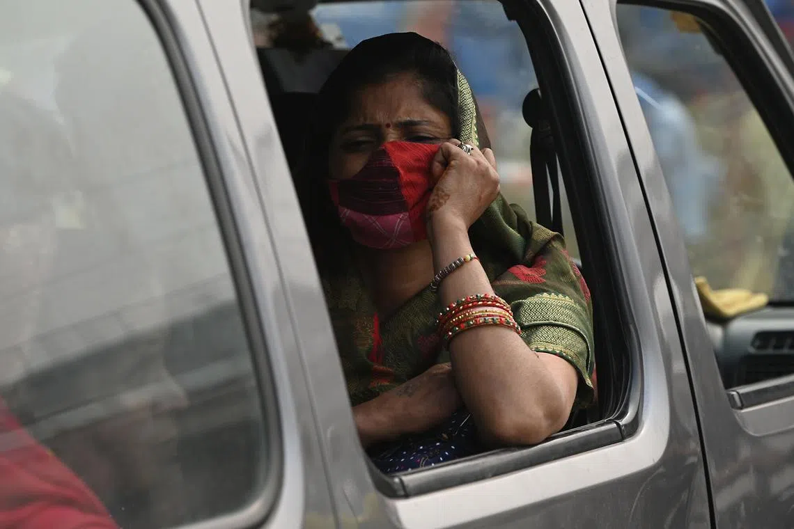 A woman wearing a face mask during her commute amid heavy smog and pollution in New Delhi, India, on Nov 4, 2023. 