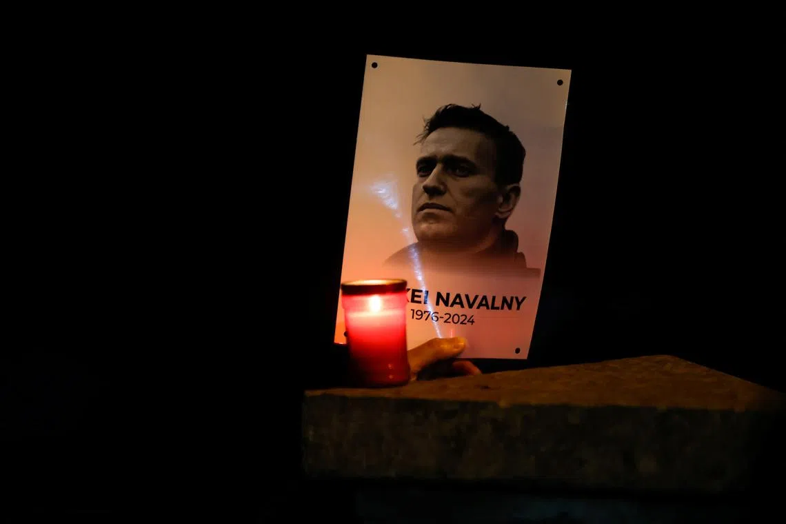 A person holds a portrait of Russian opposition leader Alexei Navalny as people attend a protest and vigil held in front of the Russian embassy following the death of Navalny, in Kappara, Malta, February 19, 2024. REUTERS/Darrin Zammit Lupi/File Photo