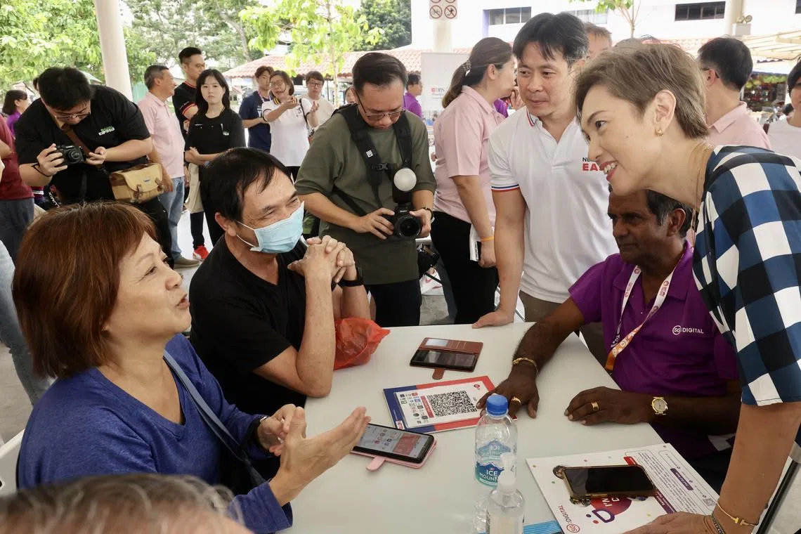 Communications and Information Minister Josephine Teo (right) at the E-Payment Learning Journey and Data for All Roadshow in Yishun on Sunday.