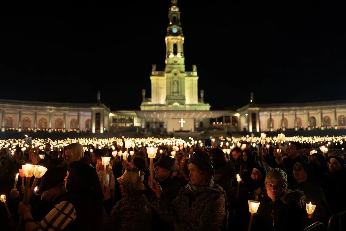 Pilgrims participate in the candlelight procession on the eve of the anniversary of the reported appearance of the Virgin Mary to three shepherd children, at the Catholic shrine of Fatima, Portugal, May 12, 2025. REUTERS/Pedro Nunes