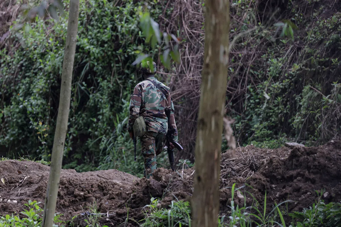 FILE PHOTO: A member of the M23 rebel group walks on the outskirts of Matanda in eastern Democratic Republic of Congo, March 22, 2025. REUTERS/Zohra Bensemra/File Photo