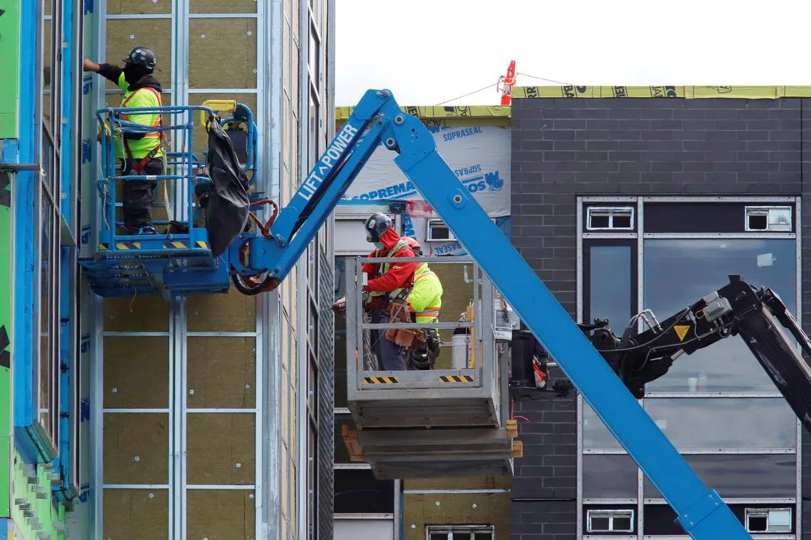FILE PHOTO: Construction workers work on a new apartment building in Ottawa, Ontario, Canada, May 27, 2021.  REUTERS/Patrick Doyle/File Photo