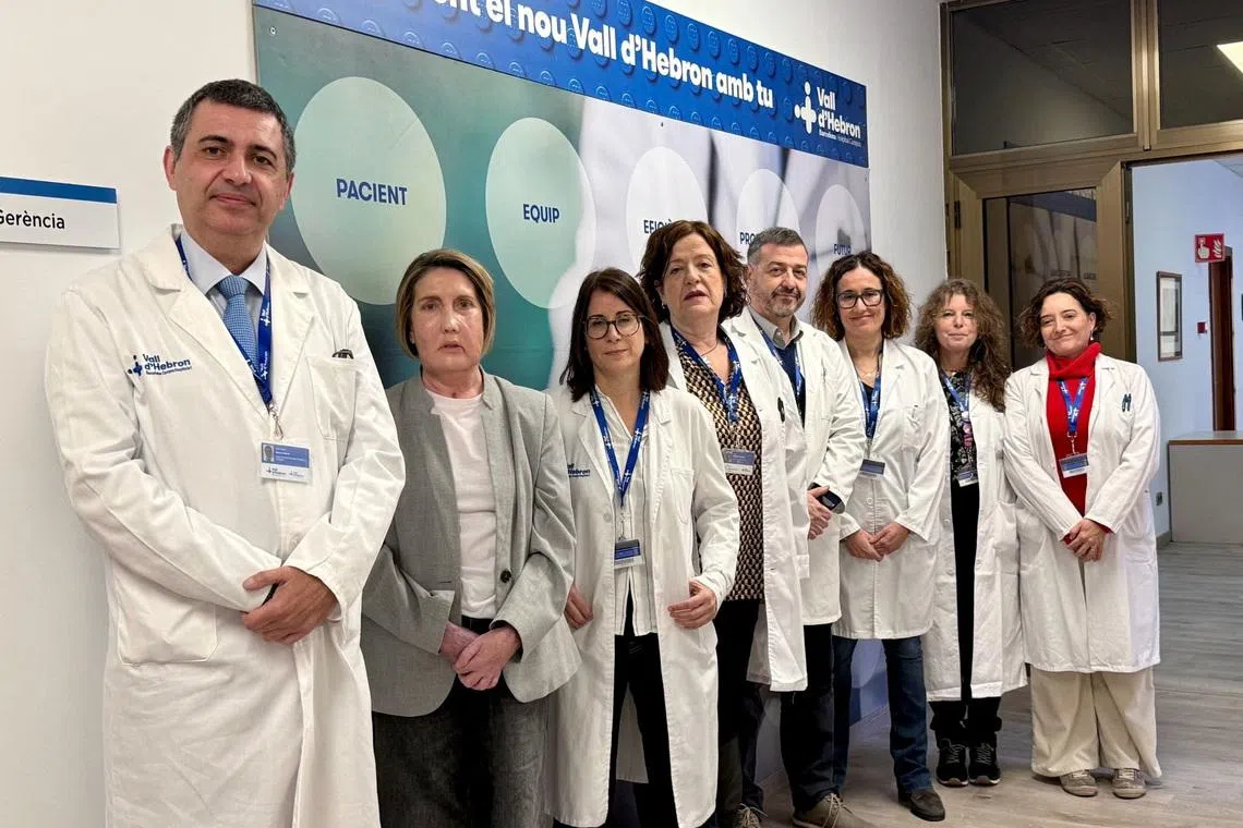 Carme, recipient of the world's first face transplant from a donor who had requested assisted dying, poses for a photo with the Hospital Vall d'Hebron surgery team, in Barcelona, Spain, February 2, 2026. Hospital Vall d'Hebron/Handout via REUTERS