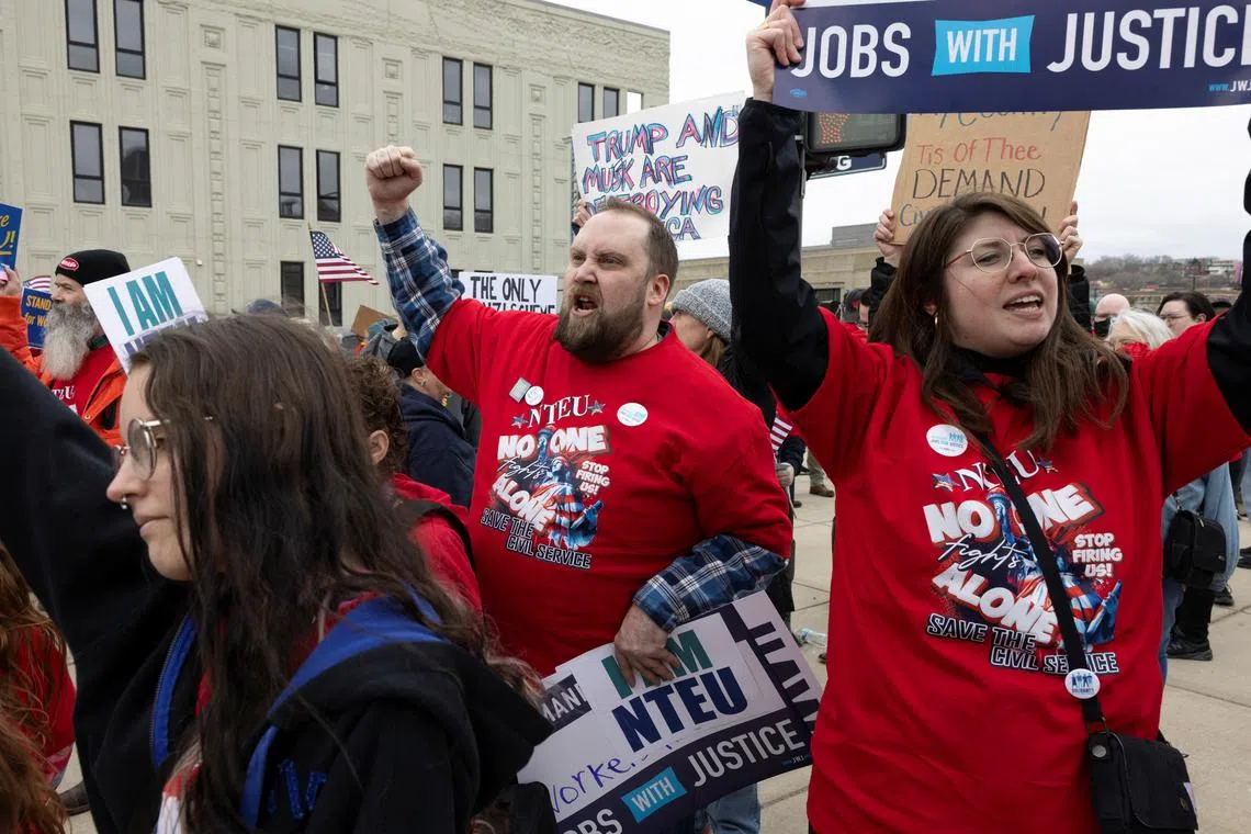 Federal workers shout chants during a rally across the street from the Internal Revenue Service headquarters in Kansas City, Missouri, on March 15.