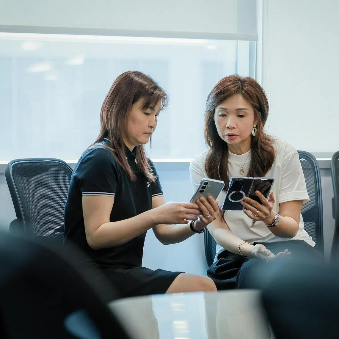 Daughters of scam victim Ms Ms Faith Phua (black top), 43, and Ms Sarah Phua (white top), 45, in an interview with the media  at Police Cantonment Complex on March 24, 2026.