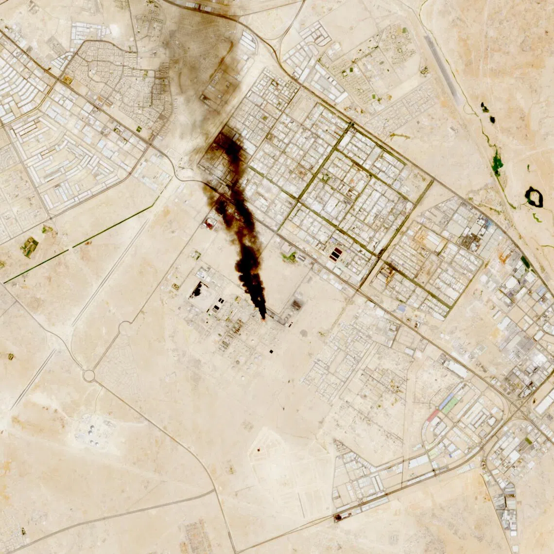 Smoke rising from the site of the Saudi Aramco refinery after reported Houthi attacks, in this handout satellite image taken on Oct 3.
