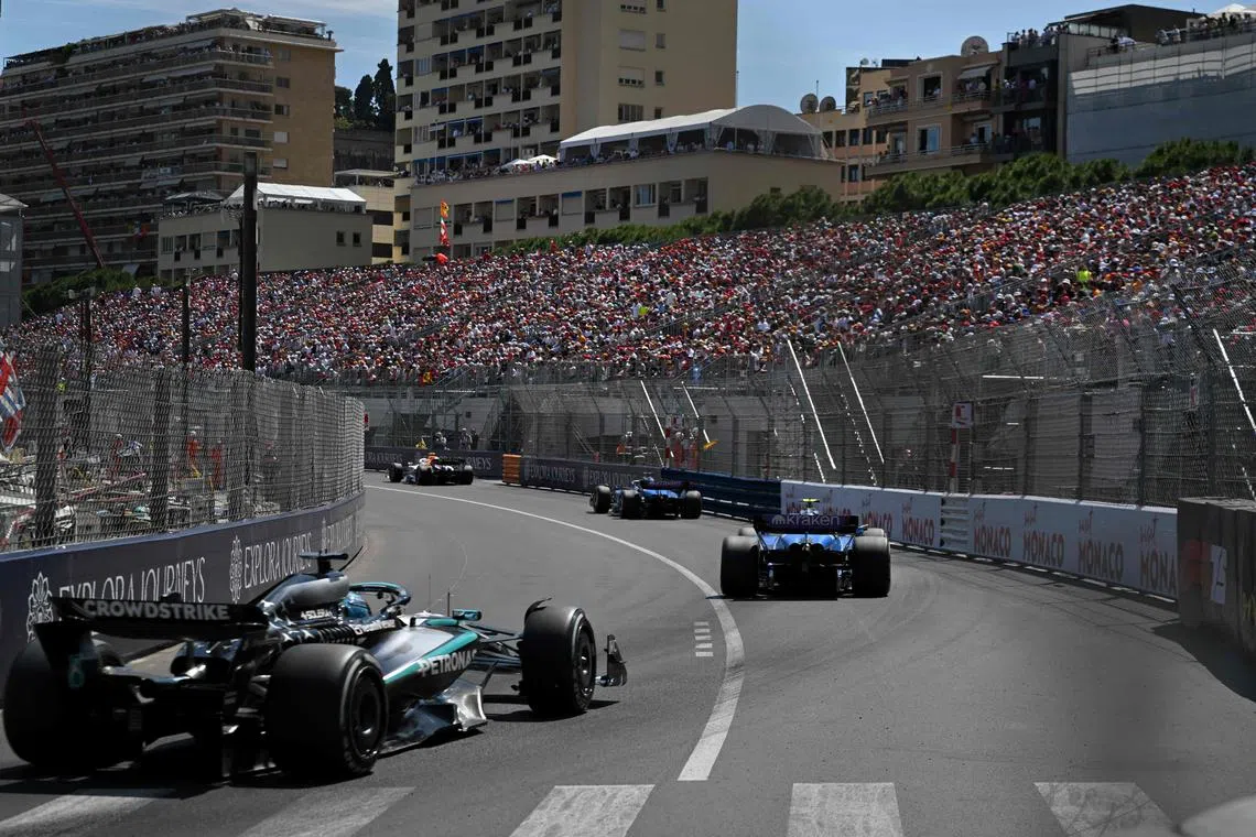 Mercedes' George Russell (eft) races behind the Williams cars during the Monaco Grand Prix.