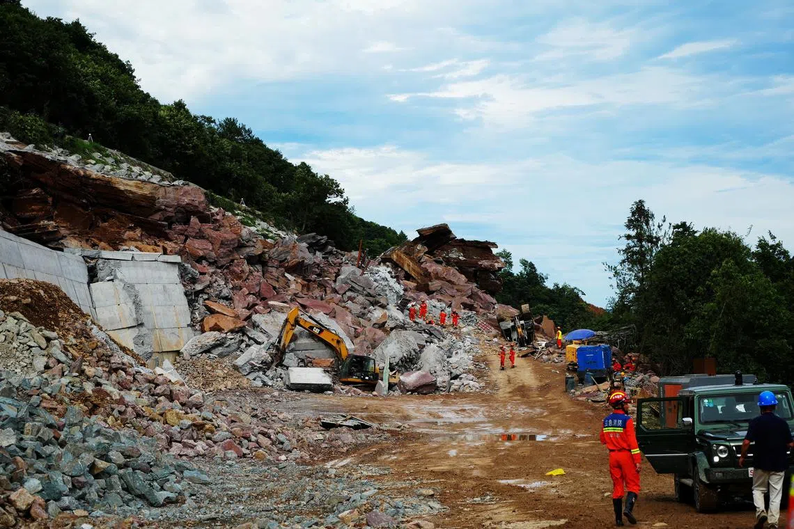 Rescuers work at the site after a landslide overtook the highway construction site on an expressway in Wufeng county, Hubei province, China July 9, 2023. cnsphoto via REUTERS ATTENTION EDITORS - THIS IMAGE WAS PROVIDED BY A THIRD PARTY. CHINA OUT.