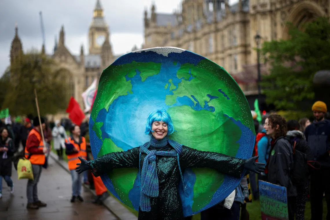 A demonstrator wears a costume as people protest during the Extinction Rebellion's 'The Big One' event, in London, Britain, April 21, 2023. REUTERS/Henry Nicholls     TPX IMAGES OF THE DAY     
