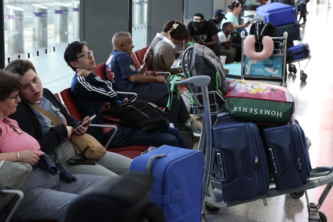 Passengers wait in a departure lounge at Heathrow Airport in London, on Aug 28, 2023.