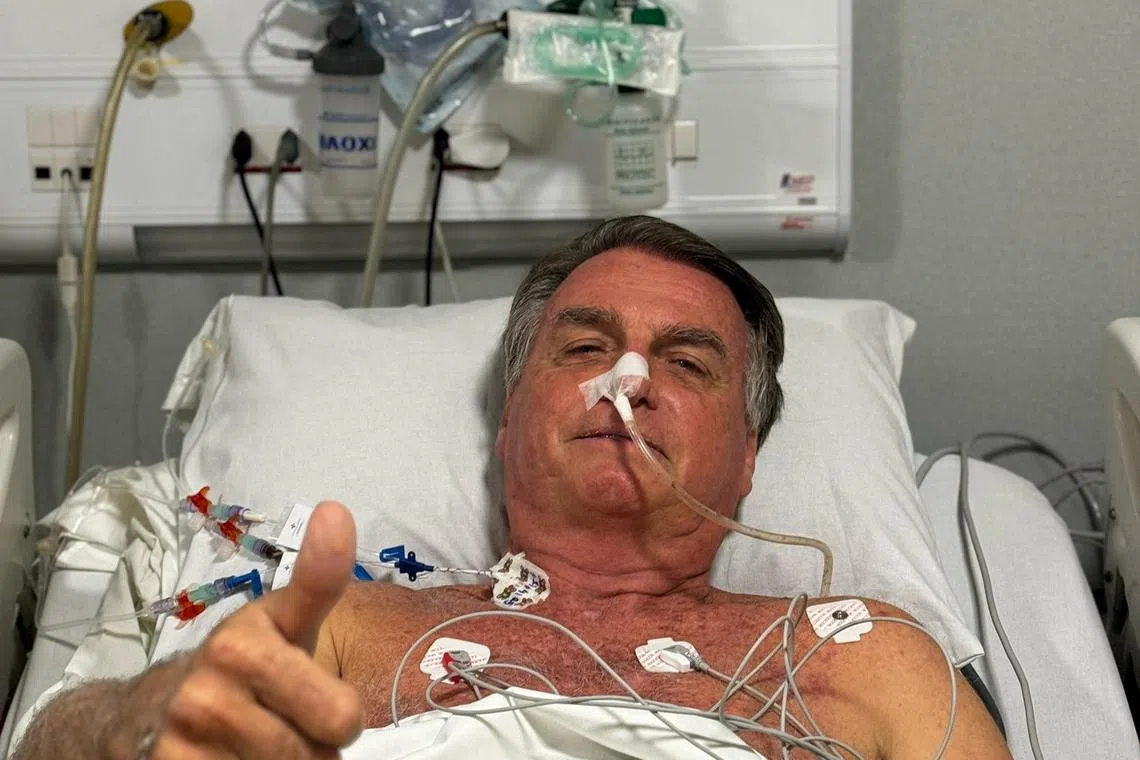 FILE PHOTO: Former Brazilian President Jair Bolsonaro gestures as he lies in a bed in Rio Grande Hospital, in Natal, Brazil, in this social media picture obtained by Reuters on April 12, 2025. Jair Bolsonaro via X via REUTERS/File Photo