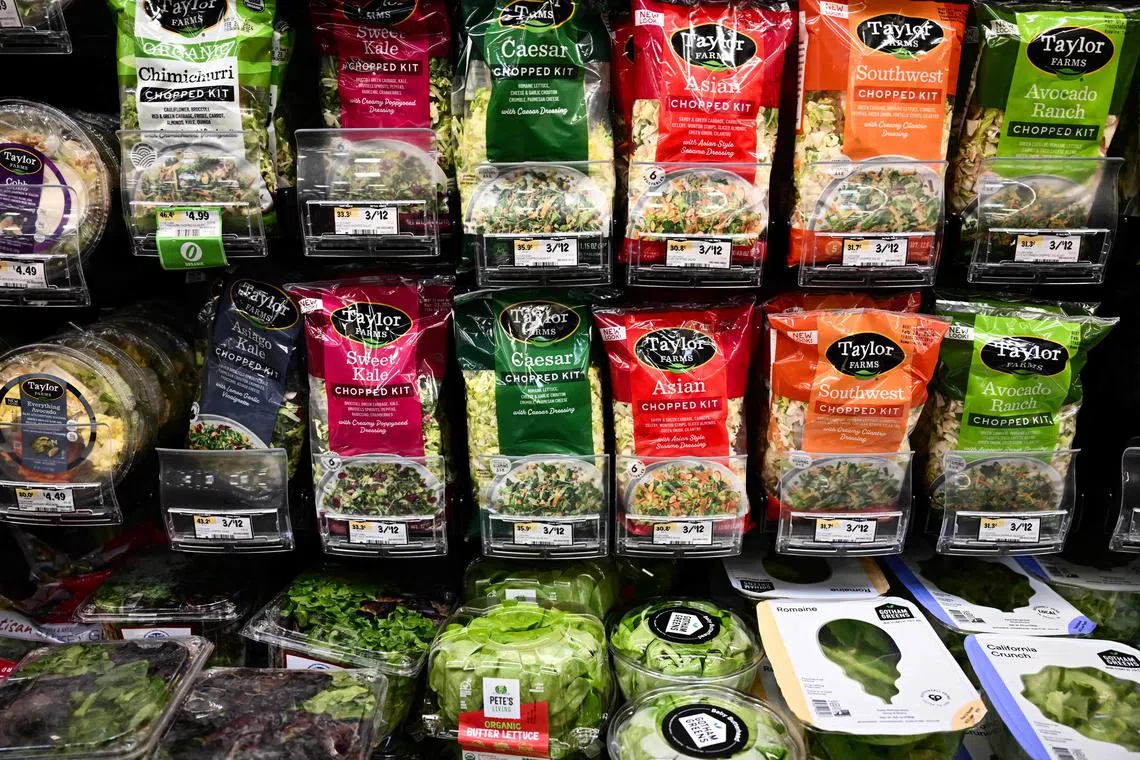 (FILES) Packages of Taylor Farms salad kits displayed for sale at a Sprouts Farmers Market grocery store in Redondo Beach, California on February 23, 2024. The US central bank's favored measure of inflation edged lower on an annual basis in January, government data showed February 29, 2024, but a metric stripping out volatile food and energy prices jumped month-over-month. (Photo by Patrick T. Fallon / AFP)