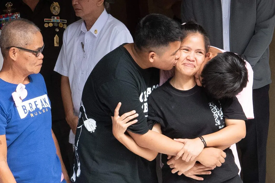 Mary Jane Veloso (second from right) is reunited with her two sons and her father (left) after she arrived at the Correctional Institution for Women in Manila.