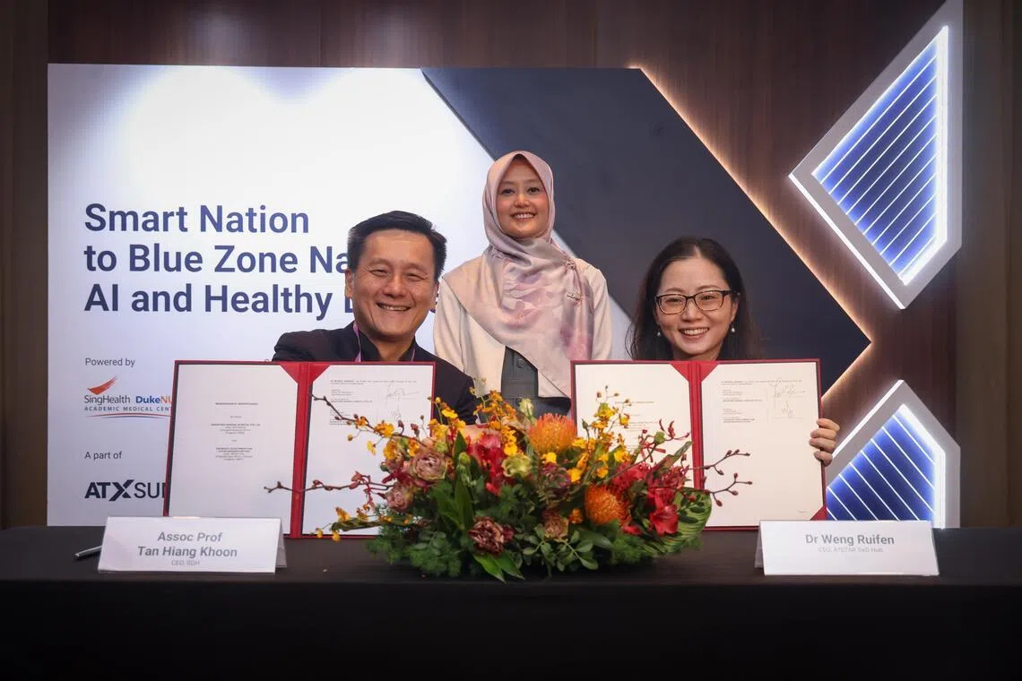 Minister of State for Health Rahayu Mahzam witnessing a MOU signing between SGH CEO Tan Hiang Khoon (left) and A*STAR DxD Hub CEO Weng Ruifen.