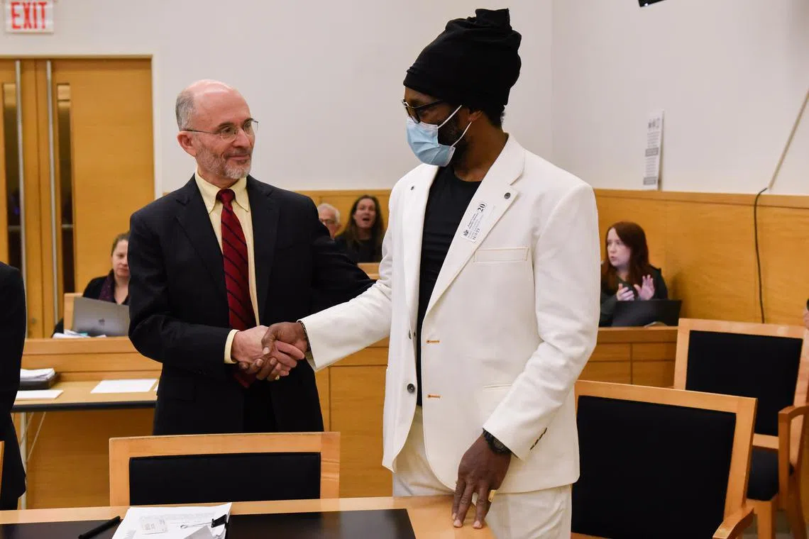 Detroy Livingston (right) receives congratulations from his lawyer, David Greenberg, after a judge vacated Livingston's 1982 conviction of second-degree murder.