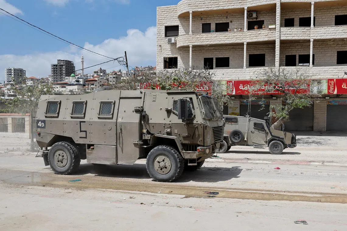 Israeli military vehicles drive during a raid, at Nour Shams camp, in Tulkarm, in the Israeli-occupied West Bank, April 19, 2024. REUTERS/Raneen Sawafta