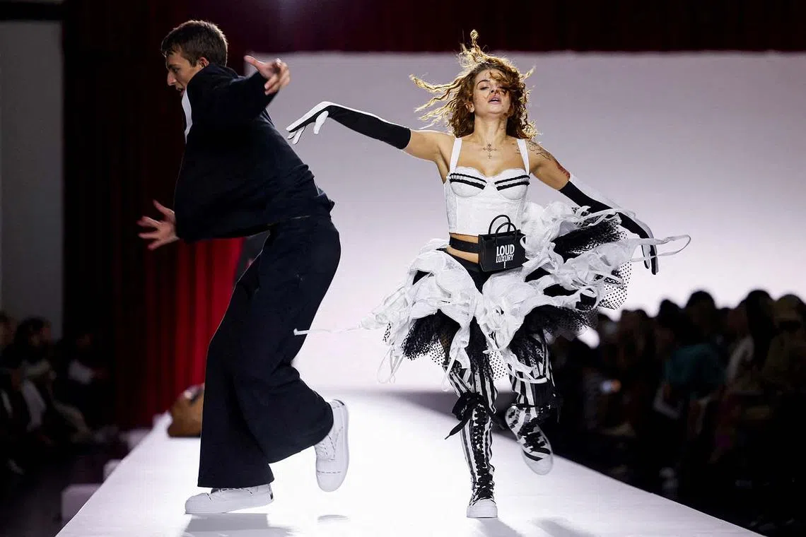 Models present creations from the Moschino Spring/Summer 2024 collection during Fashion Week in Milan, Italy, Sept 21.