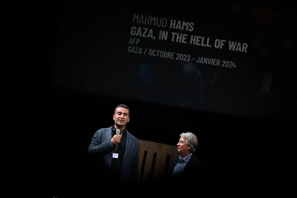 AFP photographer Mahmud Hams (left) won the top prize for photos. 