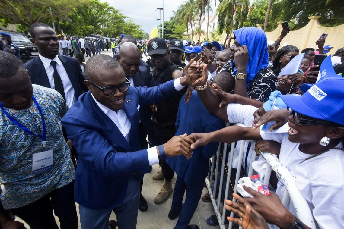 Romuald Wadagni, Benin's finance minister and the ruling party candidate for the presidential election, shakes hands with supporters after presenting his platform in Cotonou, Benin March 21, 2026. REUTERS/Charles Placide Tossou