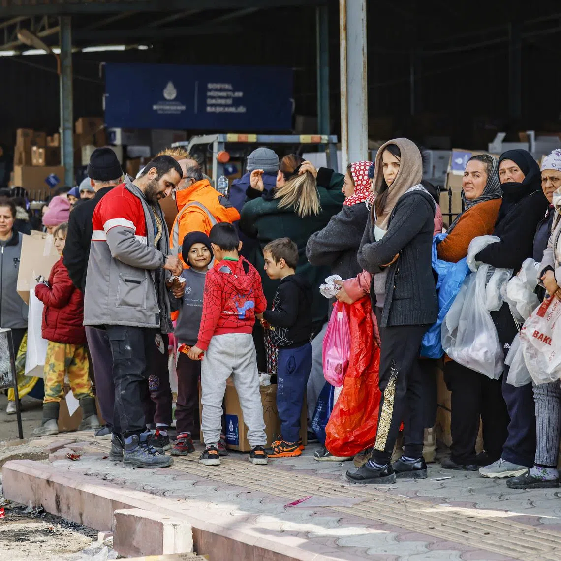 Residents queueing for humanitarian aid in Samandag, Turkey, on Sunday.