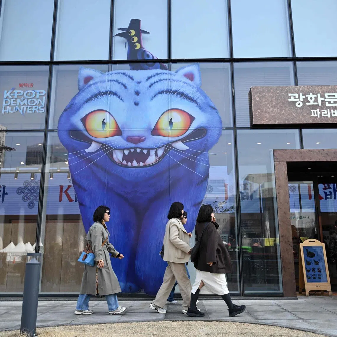 A glass wall displaying characters from Kpop Demon Hunters at a bakery in Seoul on March 17, 2026. 