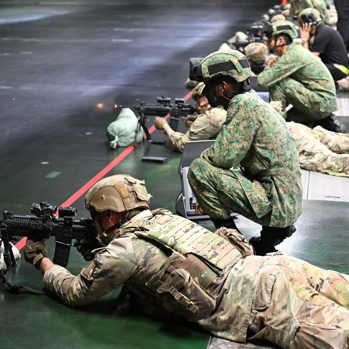 Soldiers from the Singapore Army and US Army participating in a small arms live firing as part of Exercise Lightning Strike.