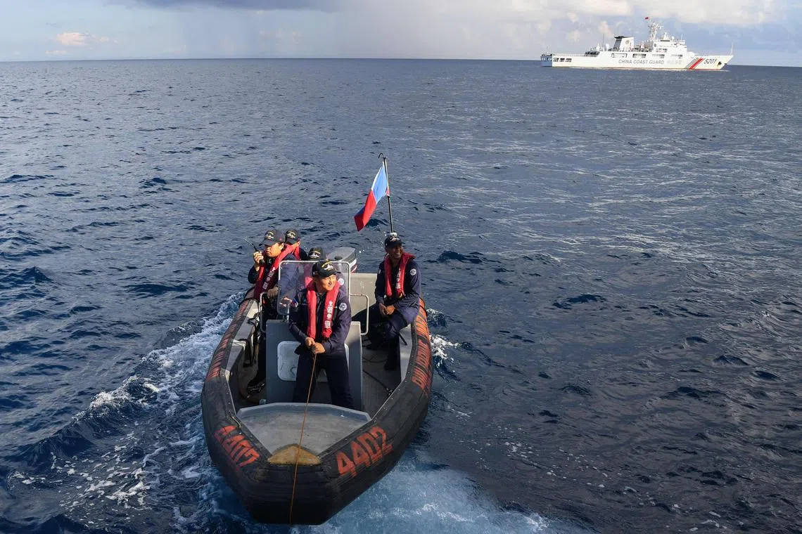 Philippine Coast Guard personnel aboard an inflatable boat preparing to conduct a survey in waters around Second Thomas shoal.