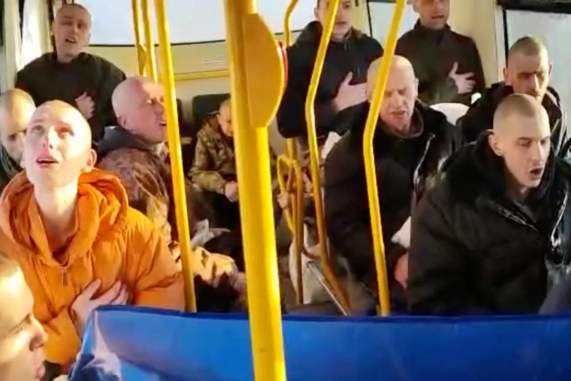 Ukrainian troops sing national anthem after being released in a prisoner swap with Russia.