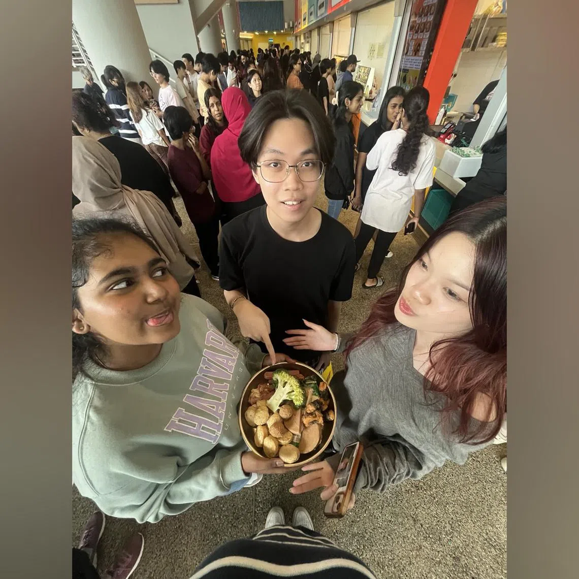 Republic Polytechnic (RP) student Shabhreen Bhanoo Mohamed Rafi with her friends at the RP campus' South Food Court during lunch break.