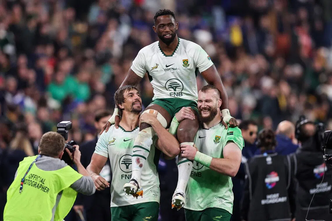 South African locks Eben Etzebeth (left) and R.G. Snyman carrying captain Siya Kolisi after his 100th Springbok appearance ends in a 32-17 win over France at the Stade de France Nov 8, 2025.