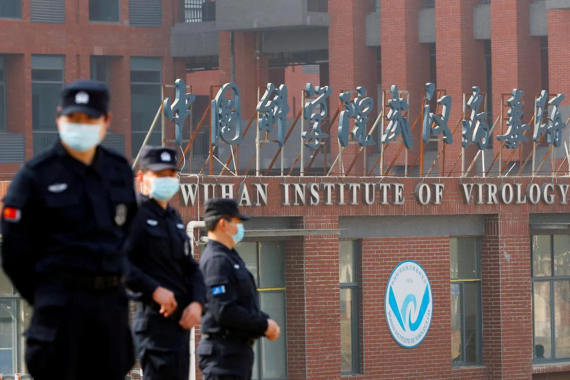 FILE PHOTO: Security personnel keep watch outside Wuhan Institute of Virology during the visit by the World Health Organization (WHO) team tasked with investigating the origins of the coronavirus disease (COVID-19), in Wuhan, Hubei province, China February 3, 2021. REUTERS/Thomas Peter/File Photo