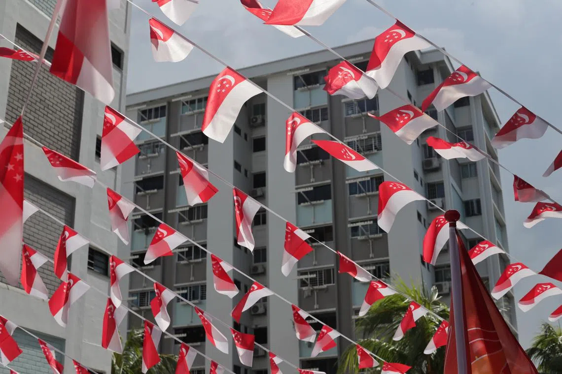 ST20230717_202361665334: Gin Tay/ pixgeneric/ Generic photo of flats along Ang Mo Kio Ave 8 decorated with Singapore flags on July 17, 2023. Can use for stories on NDP, Singapore, nation, history, state flag, harmony, racial society, National Day, independence,