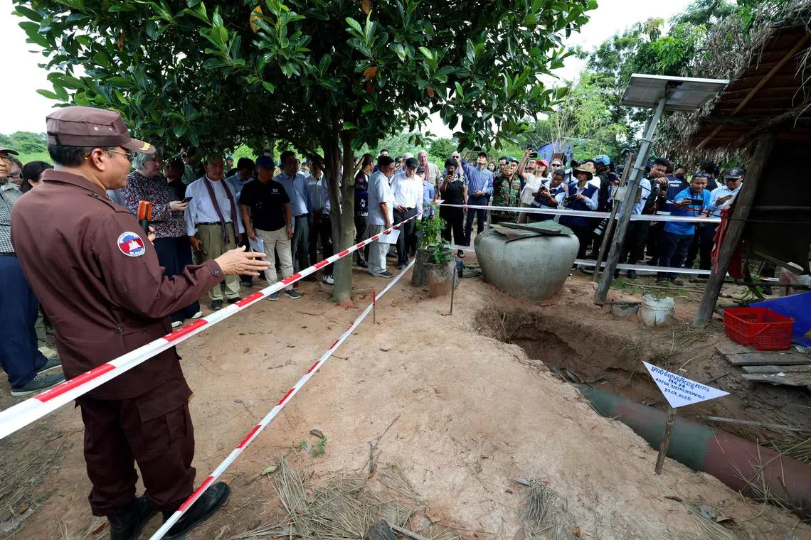 This pool photo taken and released on August 22, 2025 by Agence Kampuchea Presse (AKP) shows a bomb dropped by the Thai military during the July border clashes between Cambodia and Thailand in a village in Oddar Meanchey province. A long-running border row between the Southeast Asian neighbours boiled over into conflict in July involving artillery bombardments, air strikes and infantry clashes, killing at least 43 people and forcing more than 300,000 others to flee their homes. (Photo by POOL / AFP)