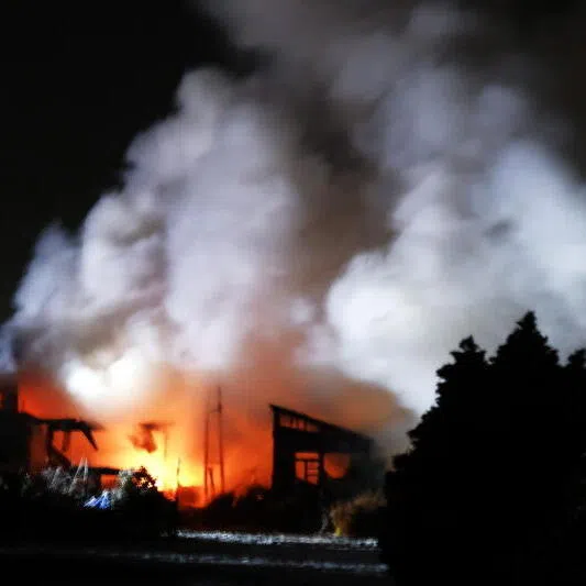 A house burns after a powerful earthquake in Aomori, north-eastern Japan, early Dec 9.
