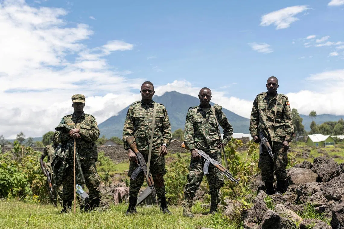 FILE PHOTO: Members of the Ugandan army, part of the troops to the East Africa Community Regional Force (EACRF), stand at a settlement ceded by M23 rebels fighters to EACRF soldiers in Bunagana, Rutshuru territory of the North Kivu province of the Democratic Republic of Congo April 19, 2023. REUTERS/Arlette Bashizi/File Photo