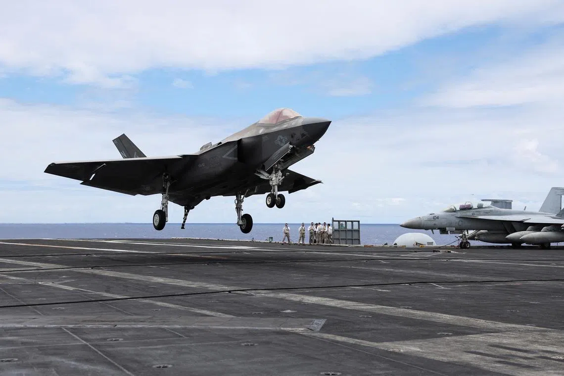 FILE PHOTO: An F-35 jet lands on the runway of the USS Carl Vinson aircraft carrier during the Rim of the Pacific (RIMPAC) military exercises about 100 miles south of Oahu, Hawaii, U.S. July 19, 2024.  REUTERS/Marco Garcia/File Photo