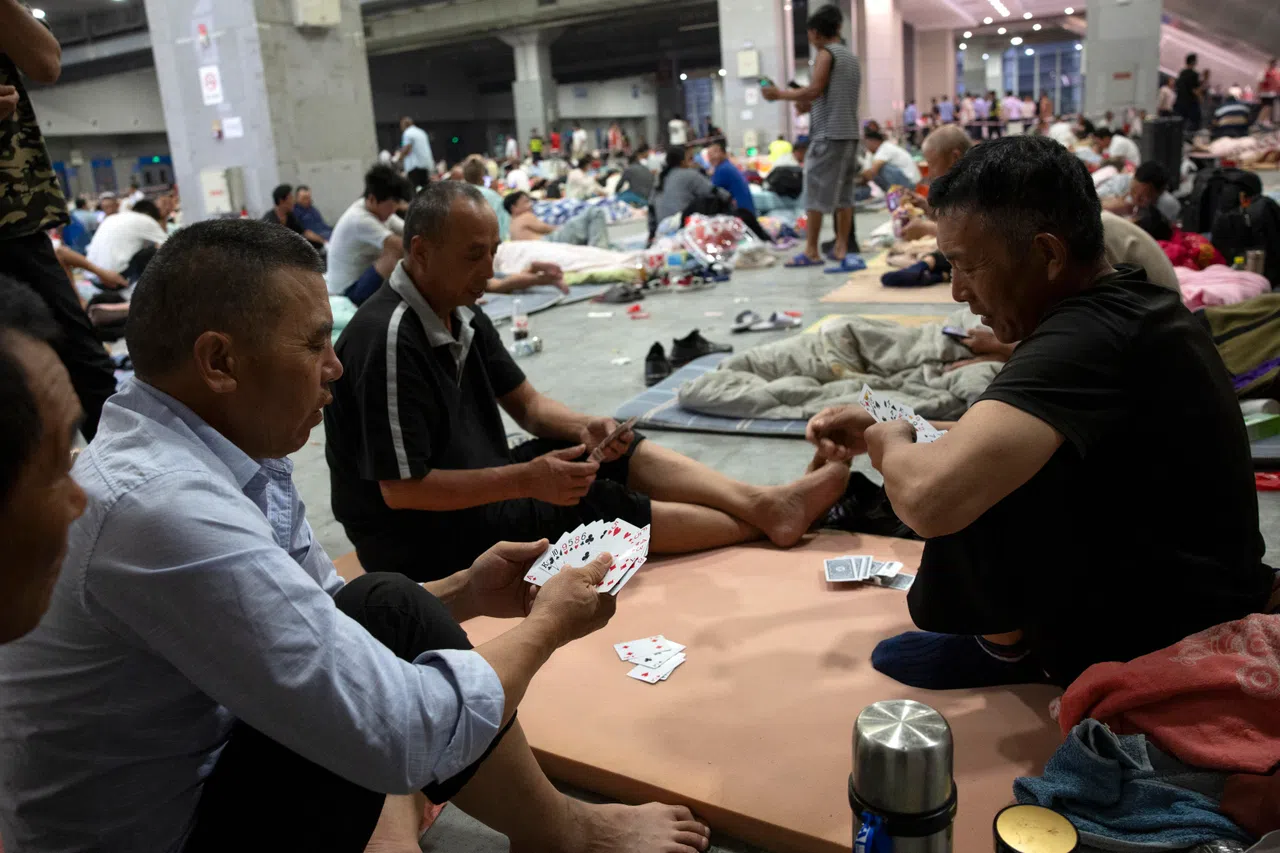 epa13104684 Workers play cards at a shelter set up ahead of Typhoon Bavi's landfall, in Wenzhou, Zhejiang province, eastern China, 11 July 2026. China's National Meteorological Center (NMC) has issued several typhoon alerts ahead of Typhoon Bavi's expected landfall along the East China coastline between the evening of 11 July and early 12 July. Coastal areas in Zhejiang and Fujian provinces could see torrential rainfall of 250 to 400 millimeters.  EPA/ANDRES MARTINEZ CASARES