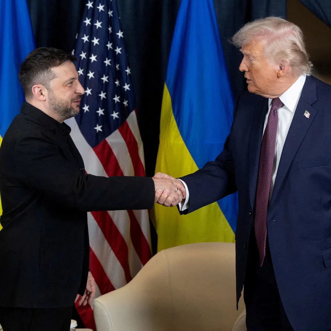 Ukraine’s President Volodymyr Zelensky and US President Donald Trump shake hands during their meeting on Jan 22, on the sidelines of the World Economic Forum in Davos, Switzerland.