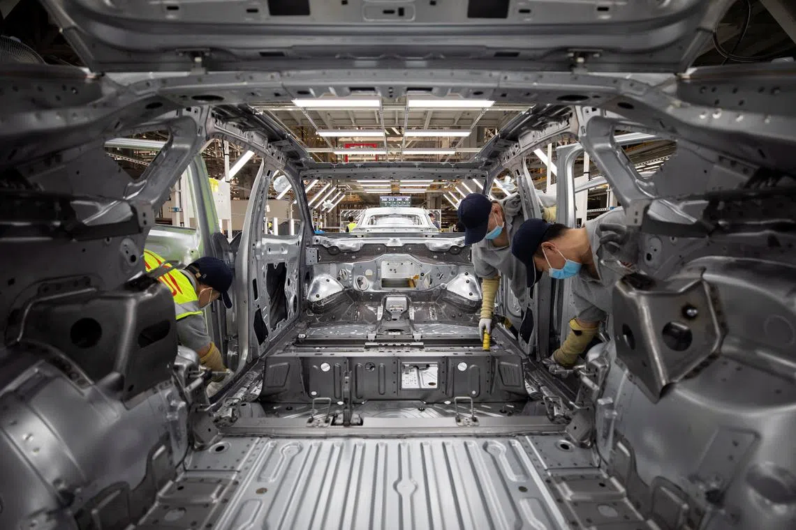 Employees work on an electric vehicle (EV) production line at a Volkswagen Anhui factory in Hefei, Anhui province, China September 25, 2024. China Daily via REUTERS/File Photo