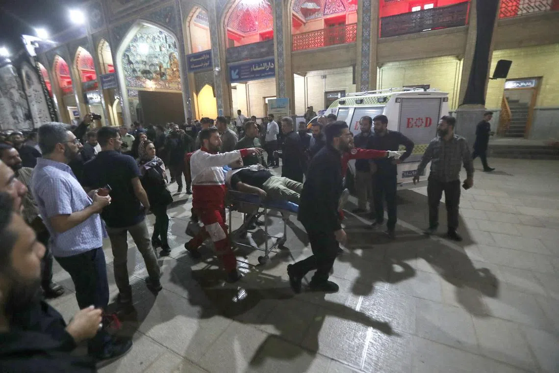 Rescuers transport an injured person after an attack in Shah Cheragh Shrine in Shiraz, Iran.