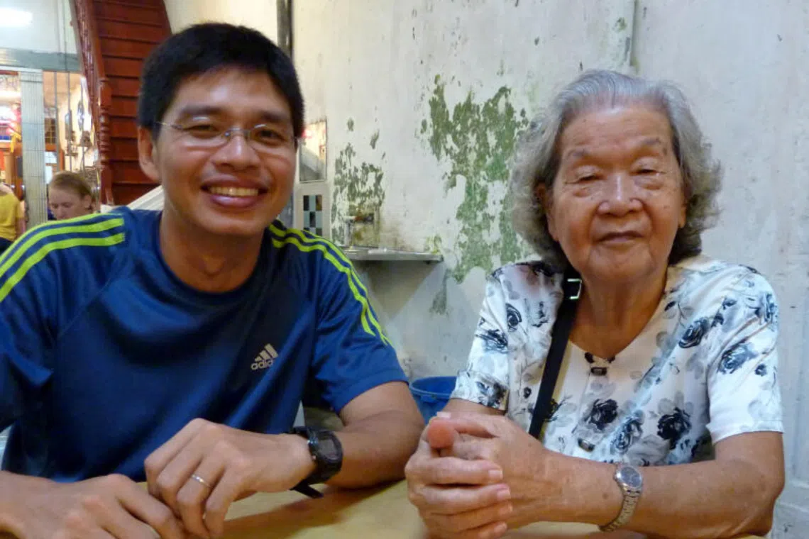 The writer with his grandmother. Their daily chats when she was alive were in Teochew, a language now he has trouble speaking.