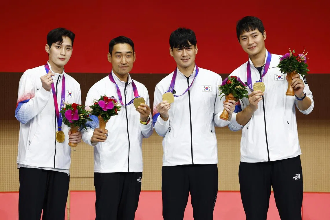 South Korea's "Avengers" Kim Jun-ho, Kim Jung-hwan, Gu Bon-gil, and Oh Sang-guk posing with their gold medals.