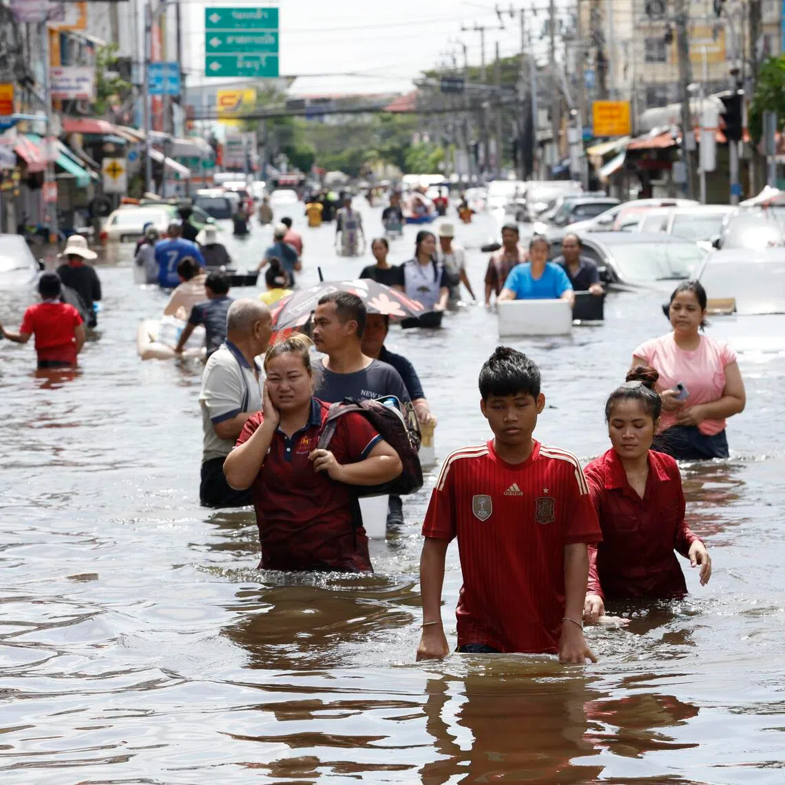 Bangkok residents wading through floodwater on Sept 29. Prime Minister Anutin Charnvirakul has instructed agencies to prepare for severe flooding and avoid a repeat of the travel chaos that accompanied the September deluge.