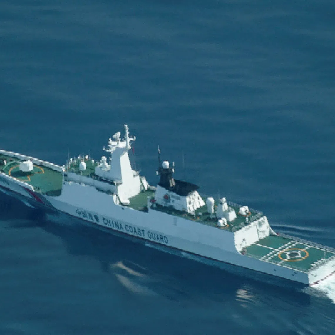 FILE PHOTO: An aerial view of a China Coast Guard ship navigating near the disputed Scarborough Shoal, as Philippine Coast Guard aircraft carrying journalists patrols the area, days after two Chinese vessels collided in the area while allegedly trying to block a Philippine supply mission, in the South China Sea, August 13, 2025. REUTERS/Adrian Portugal/File Photo