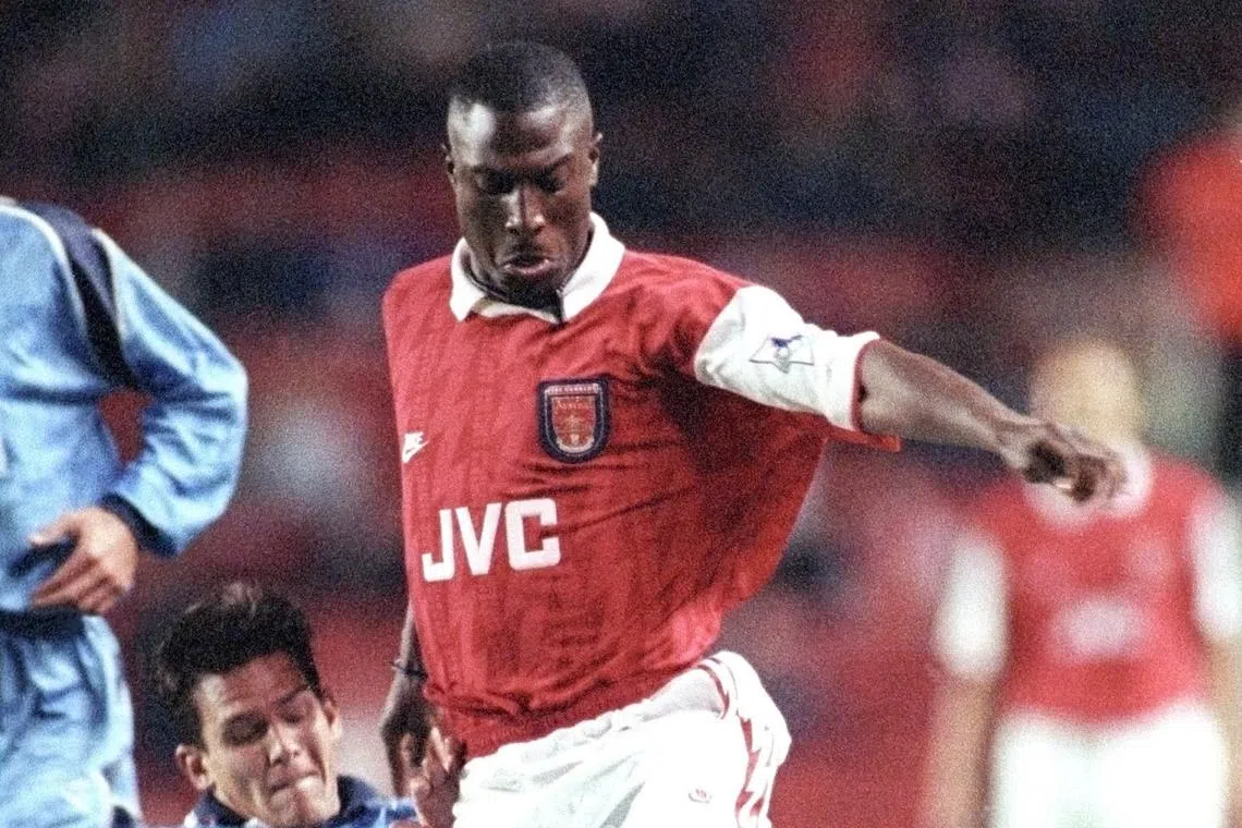 FILE PHOTO: Arsenal striker Kevin Campbell (R) is challenged by Hartlepool United's Phil Gilchrist during their League Cup second round second leg match at Highbury in London October 5, 1994. REUTERS/Dylan Martinez/File Photo