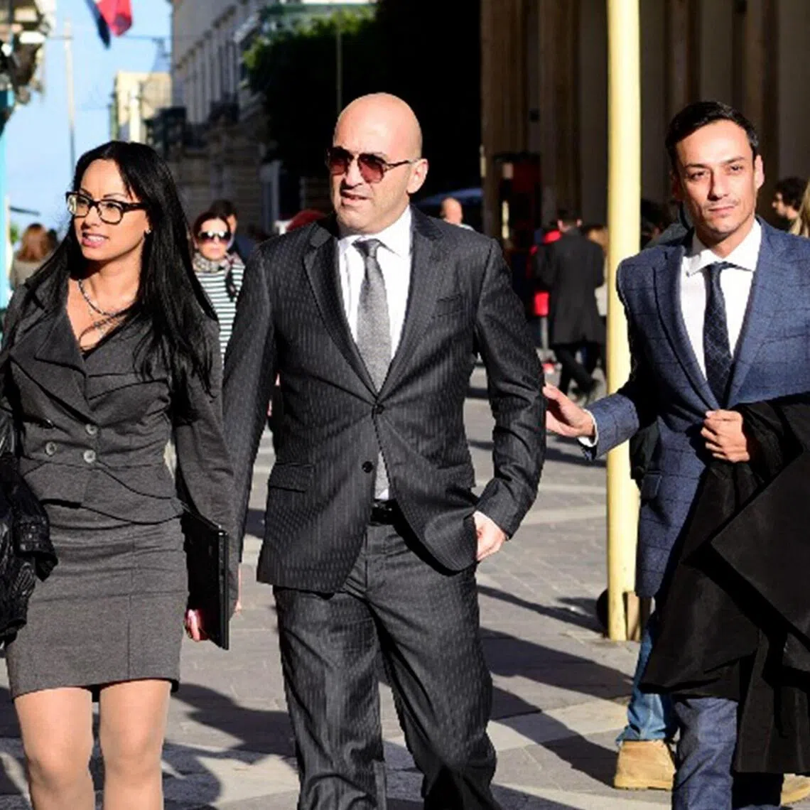 (FILES) Maltese tycoon Yorgen Fenech (C), whose business interests span the energy and tourism sectors, walks into court escorted by his lawyer Gianluca Caruana Curran (R) on November 29, 2019 in Valletta, Malta. The man accused of ordering the 2017 murder of a hard-hitting investigative journalist in Malta finally faced a court on July 1, 2026, marking a key moment in the criminal case that rocked the tiny nation. Businessman Yorgen Fenech is charged with orchestrating the assasination of Daphne Caruana Galizia, 53, a prominent public figure and vocal critic who was killed by a bomb placed in her car near her home. (Photo by AFP)