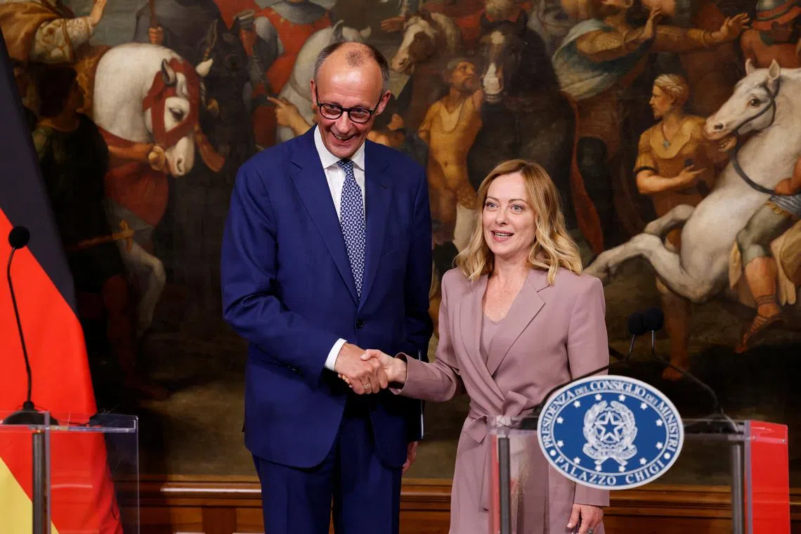 Italian Prime Minister Giorgia Meloni and German Chancellor Friedrich Merz shake hands at a press conference, at Chigi Palace in Rome, Italy, May 17, 2025. REUTERS/Remo Casilli