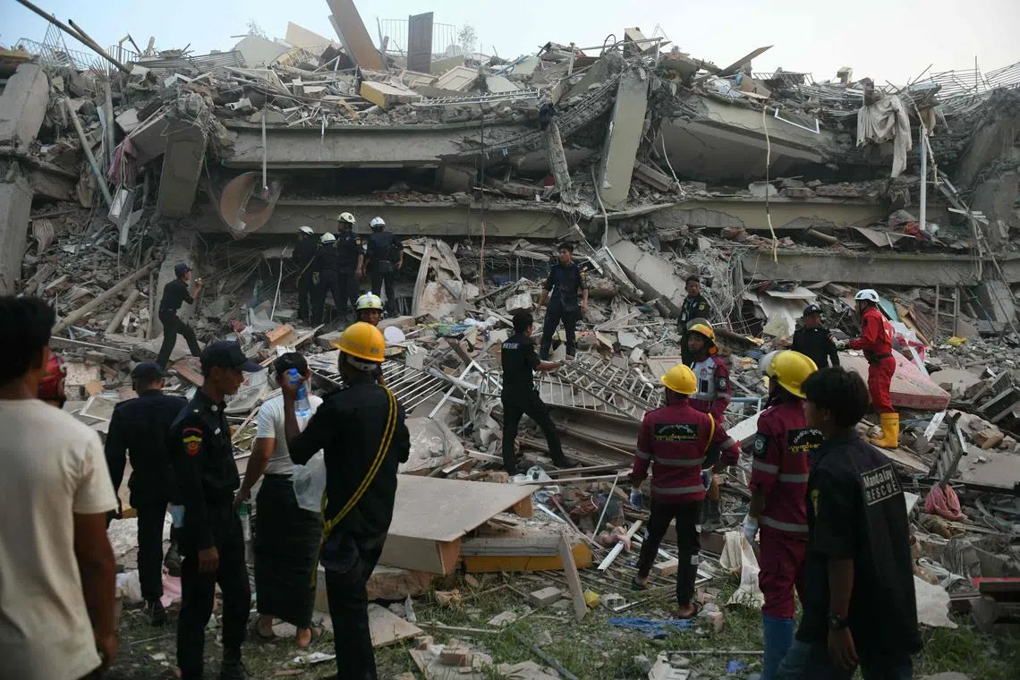 Rescuers search for survivors trapped in the collapsed Sky Villa Condominium building in Mandalay on March 29, 2025, a day after an earthquake struck central Myanmar. Rescuers pulled a woman alive from the wreckage of a collapsed apartment building in Mandalay on March 29, AFP journalists saw, 30 hours after a devastating quake hit Myanmar. (Photo by Sai Aung MAIN / AFP)